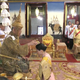 Queen Suthida kneels before the king during the ceremonies.